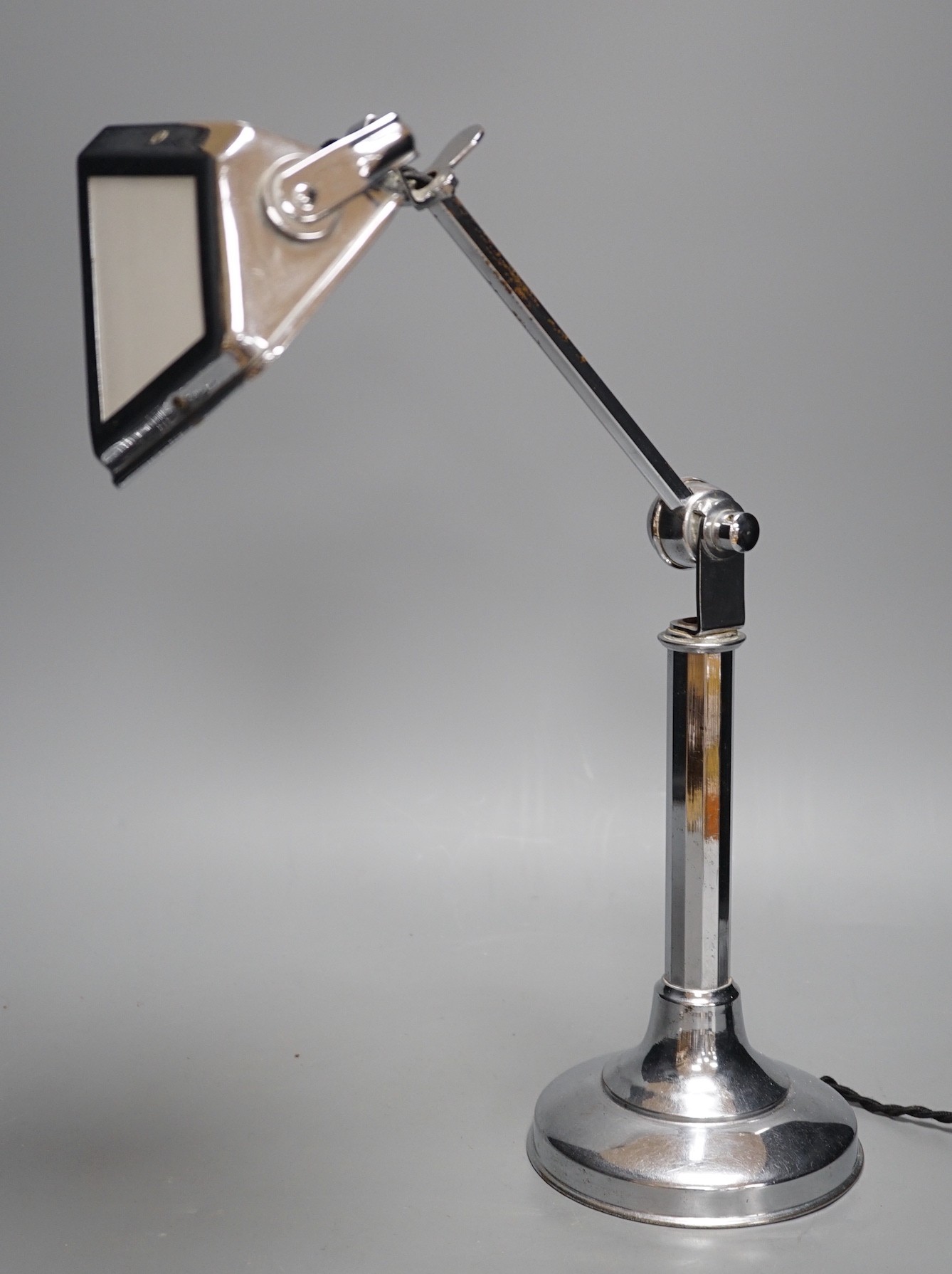 A chrome pirouette adjustable desk lamp